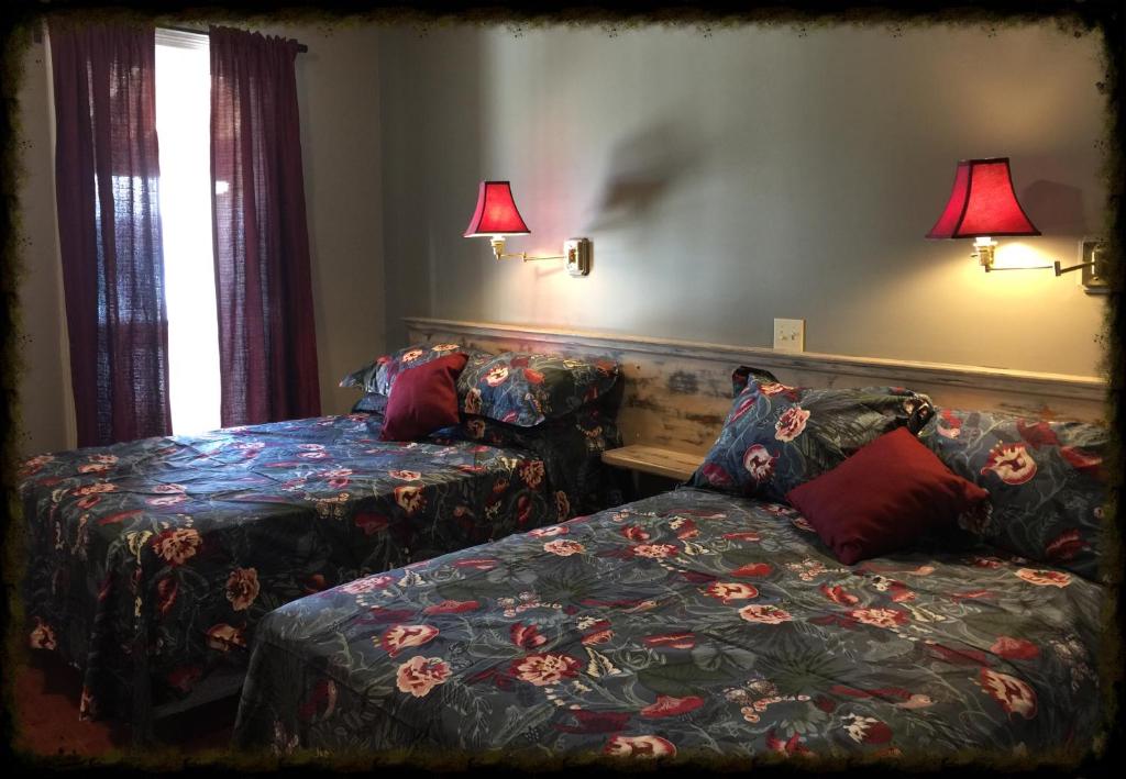 a bedroom with a bed and a couch and lamps at Shoreline Suites in Digby