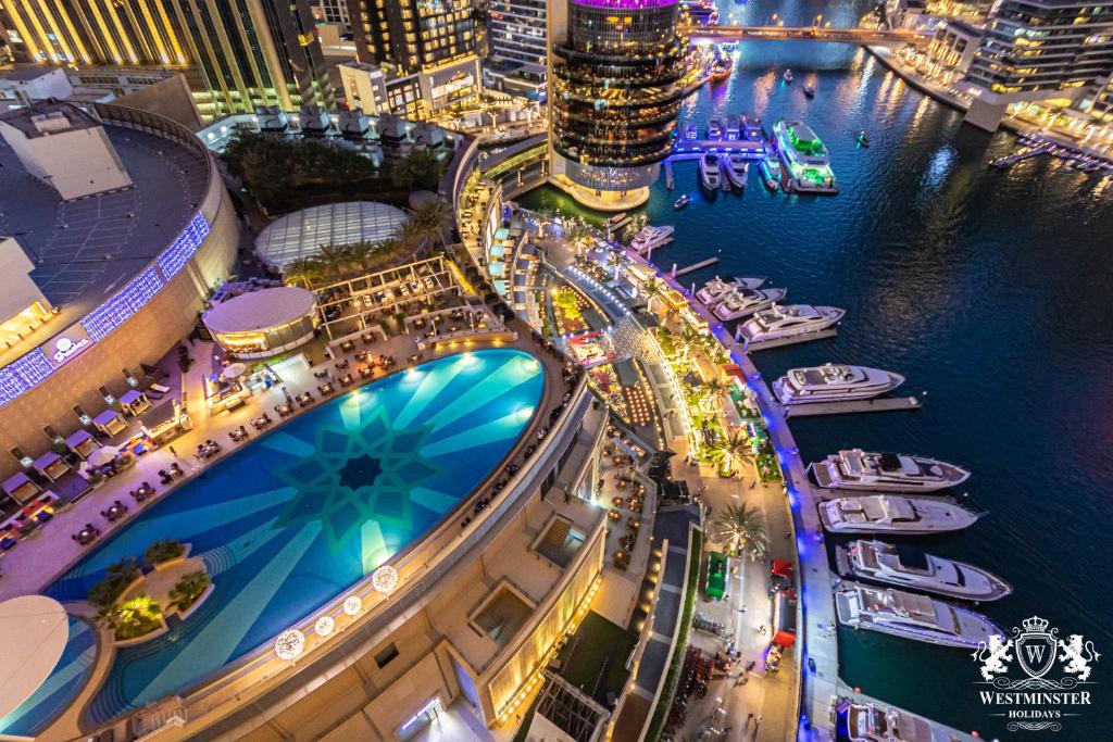 an aerial view of a marina at night with boats at Westminster Dubai Marina in Dubai