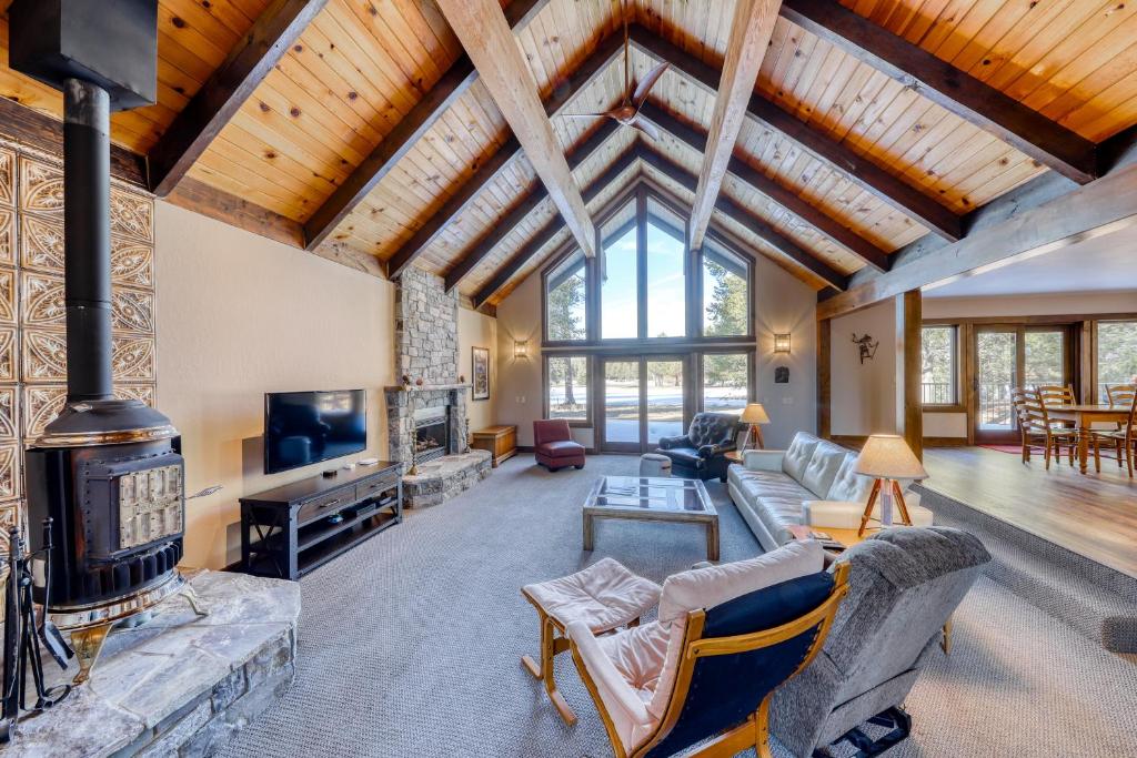 an open living room with a fireplace and a living room with at Country Club Retreat in South Lake Tahoe