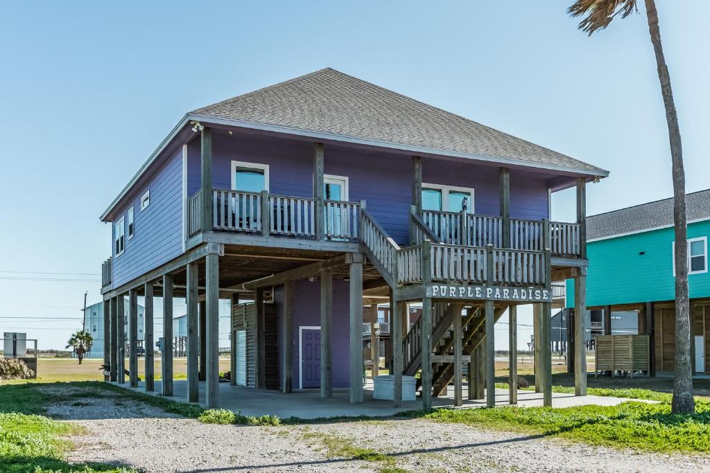 a purple house with a deck on a beach at Purple Paradise in Freeport