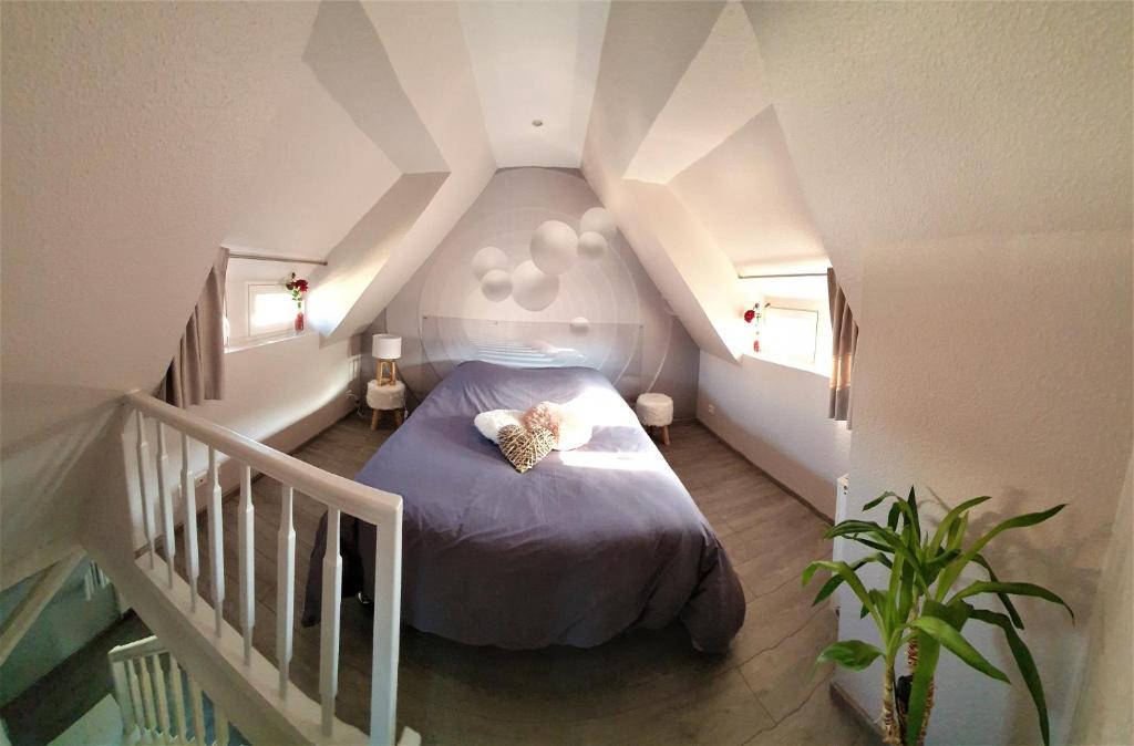 a bedroom with a bed with a teddy bear on it at CHIC & COSY in Haguenau