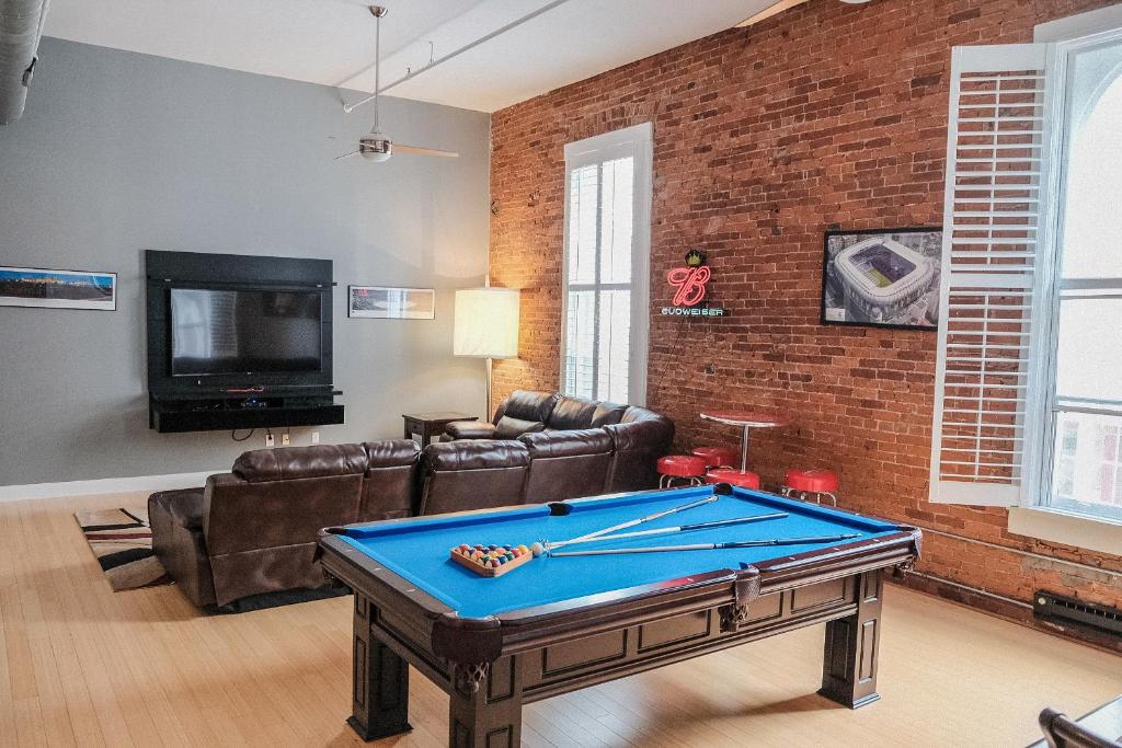 a living room with a ping pong table at Modern Lofts next to Georgia St. & Convention Ctr. in Indianapolis