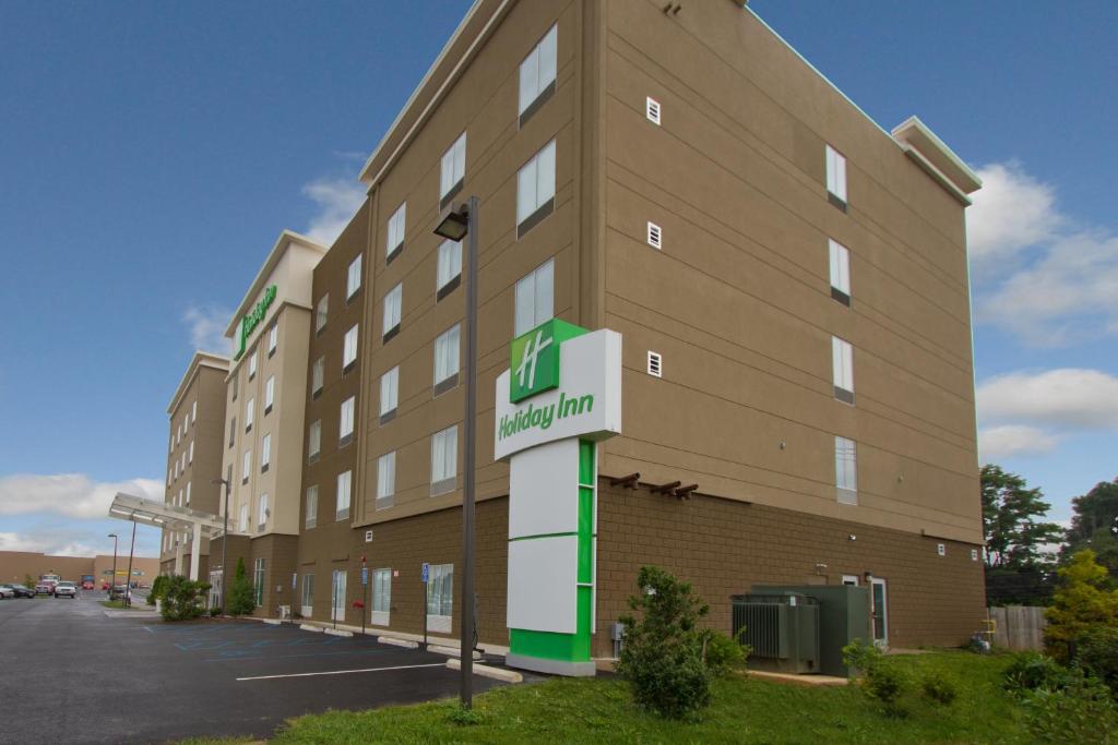 a large building with a sign in front of it at Holiday Inn Christiansburg Blacksburg, an IHG Hotel in Christiansburg