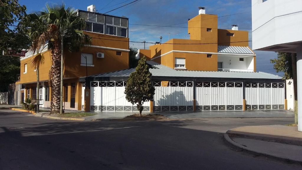 a building with a white fence next to a street at Terraza del Sol Apart in San Juan