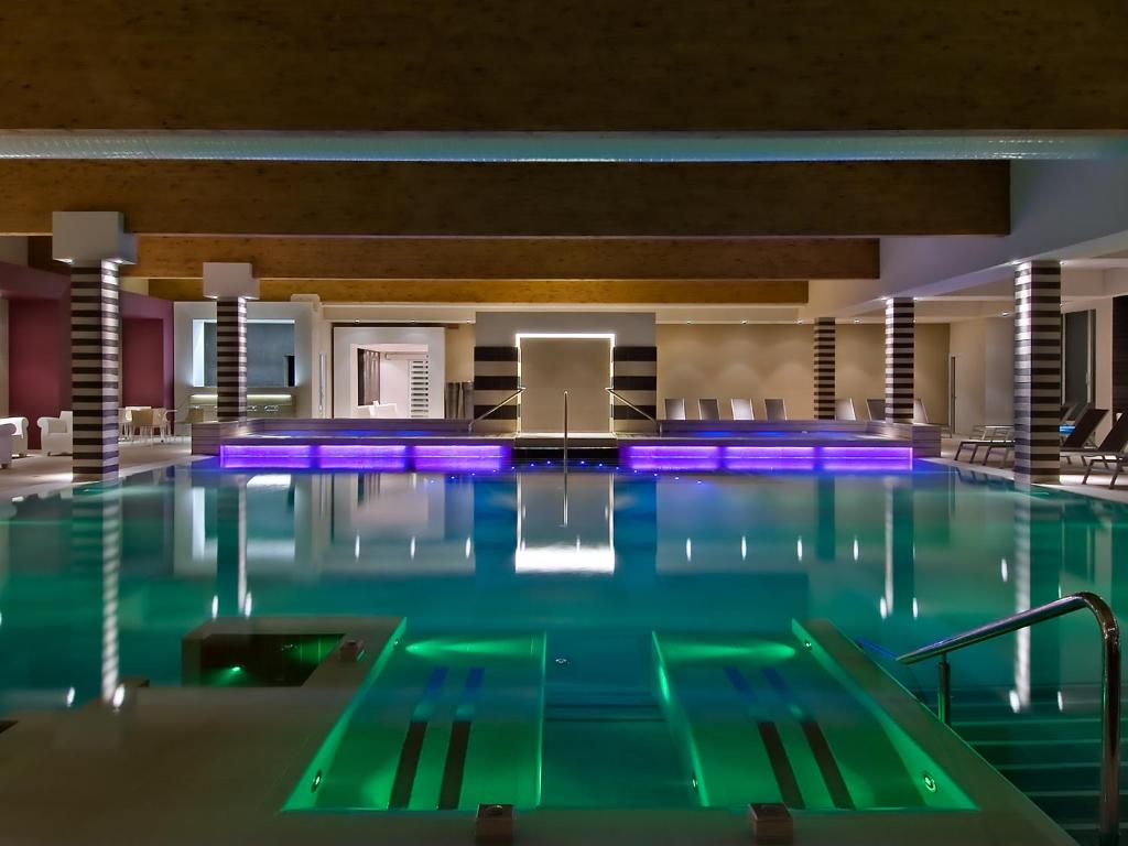 a large swimming pool in a hotel room at Hotel Mioni Pezzato in Abano Terme