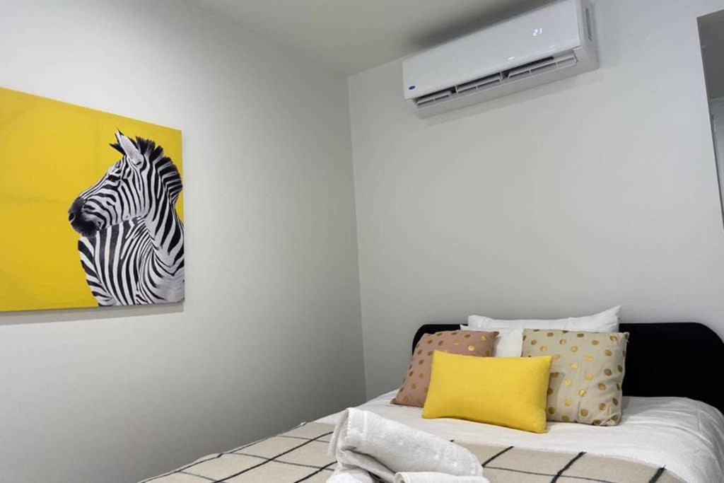 a bedroom with a zebra picture on the wall at 10A Brunswick Living Studio Close to APT and CBD Free Wifi Tram at Doorstep in Melbourne