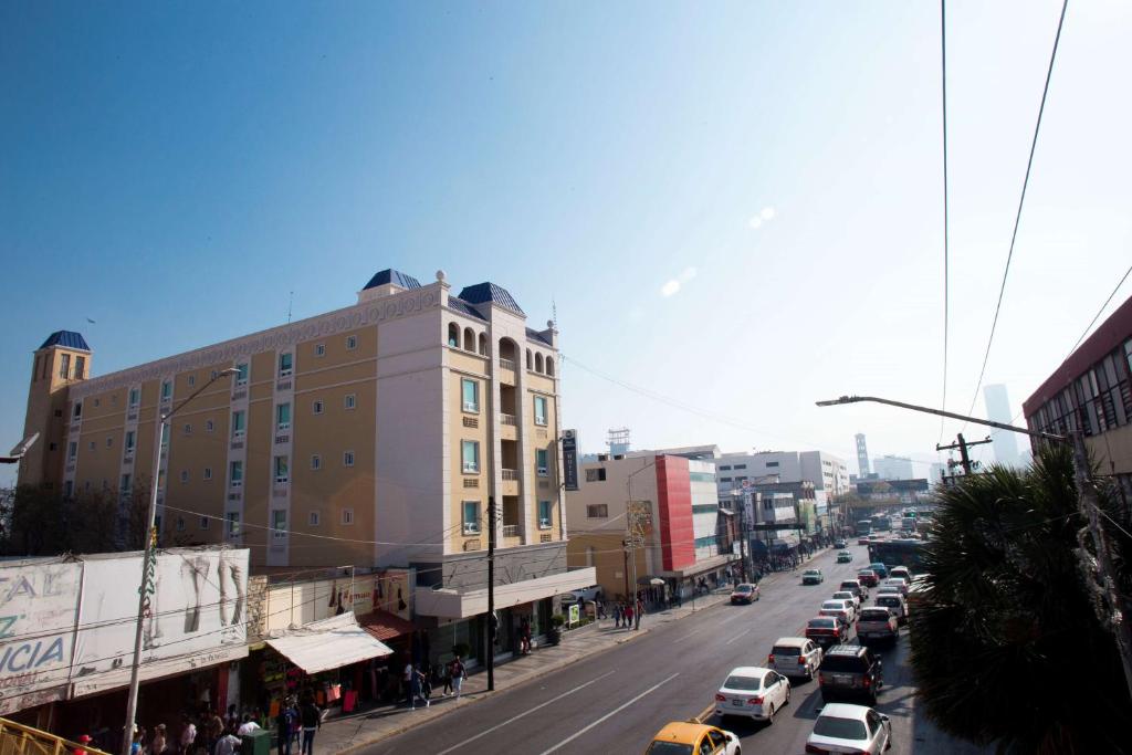 una concurrida calle de la ciudad con coches aparcados en la carretera en Best Western Centro Monterrey en Monterrey