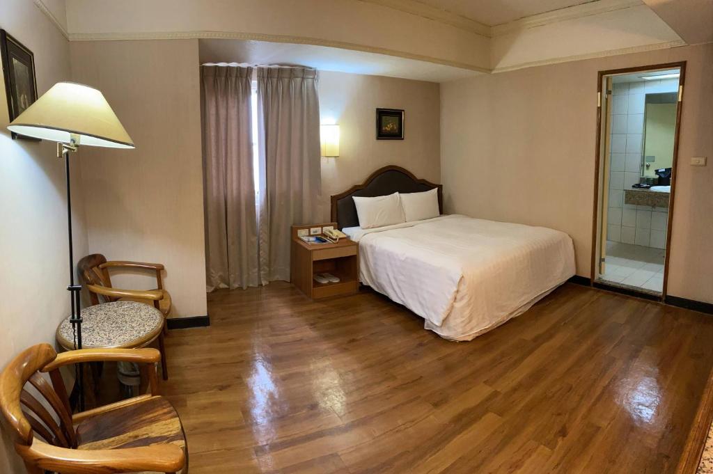 Postel nebo postele na pokoji v ubytování Tapeng Bay Holiday Hotel