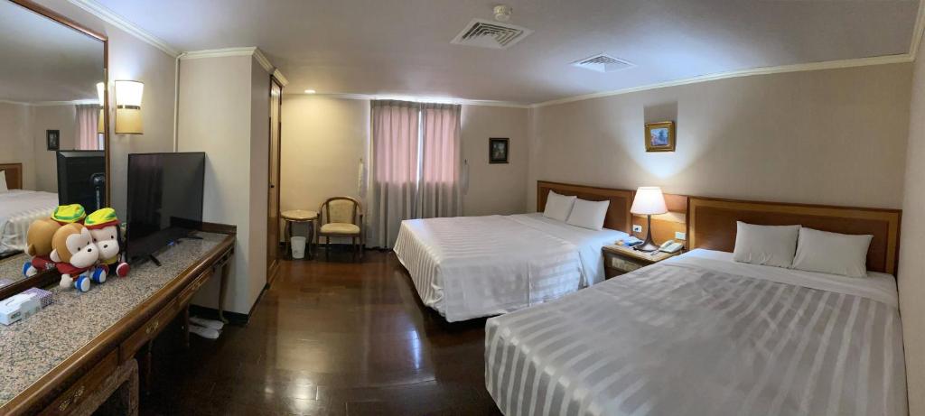 Postel nebo postele na pokoji v ubytování Tapeng Bay Holiday Hotel