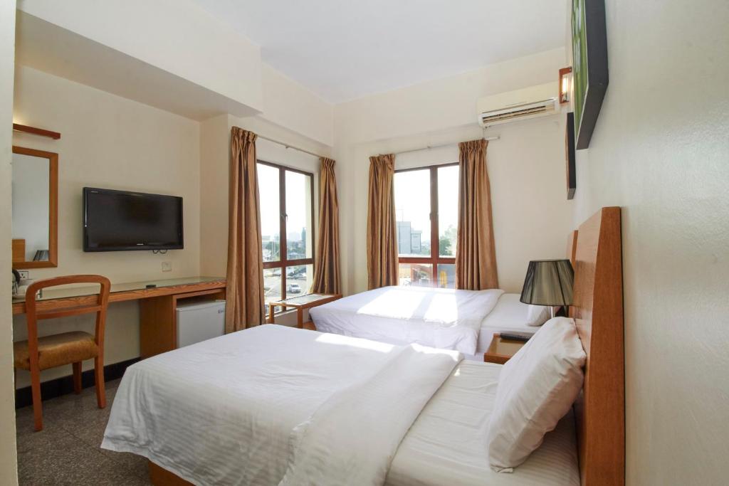 Postel nebo postele na pokoji v ubytování Kepong Hotel