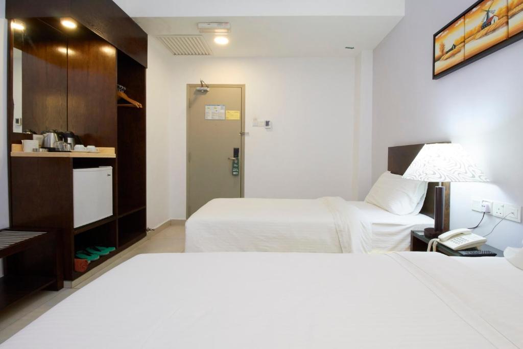 Postel nebo postele na pokoji v ubytování Kepong Hotel