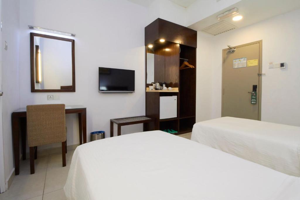 Postel nebo postele na pokoji v ubytování Kepong Hotel