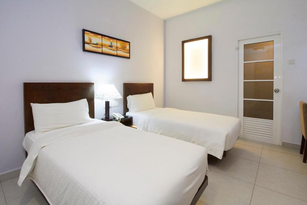 Postel nebo postele na pokoji v ubytování Kepong Hotel