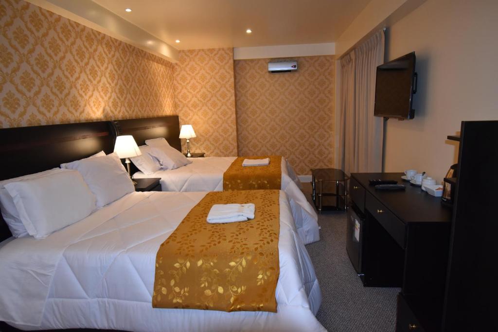 Postel nebo postele na pokoji v ubytování Hotel Paradis Suite Cusco