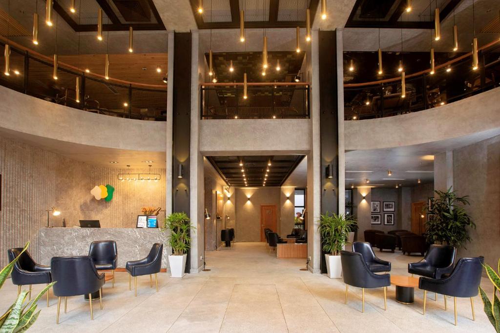 a lobby with chairs and a table in a building at Flower Garden Hotel in Hanoi