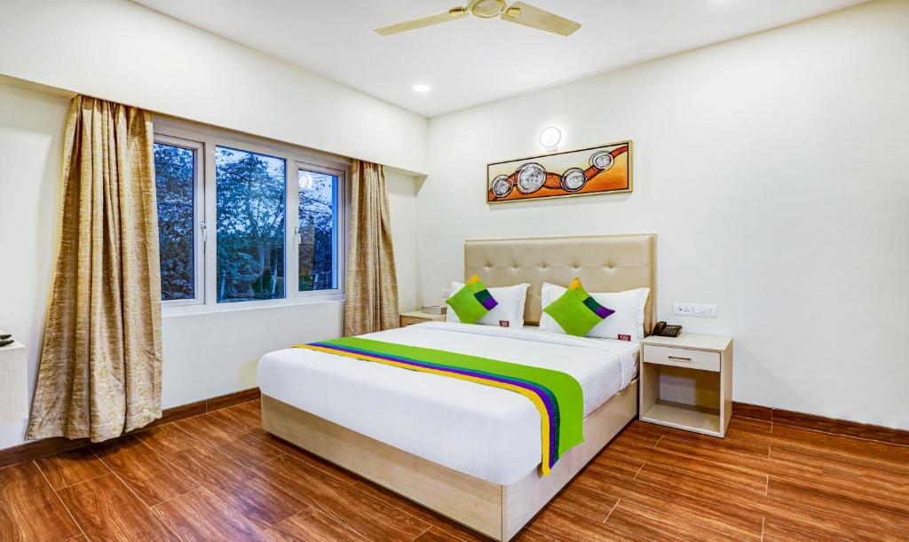 a bedroom with a bed and a window at Treebo Trend Galaxy Suites Mathikere in Bangalore