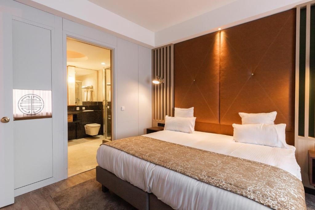 Postel nebo postele na pokoji v ubytování Shanghai Hotel Holland