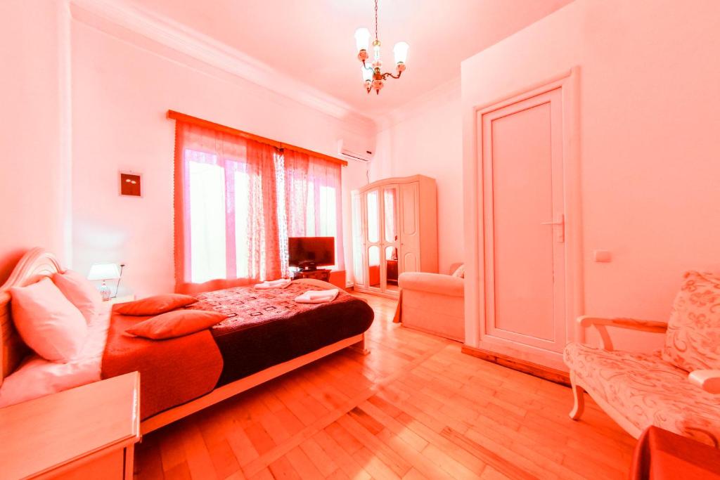 a bedroom with a bed and a couch in it at House 1899 in Kutaisi