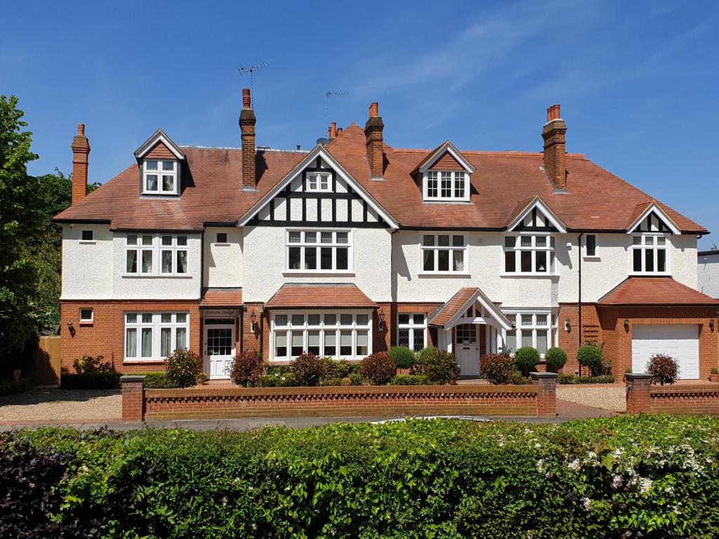 a large white house with a brown roof at Ditton Lodge in Kingston upon Thames