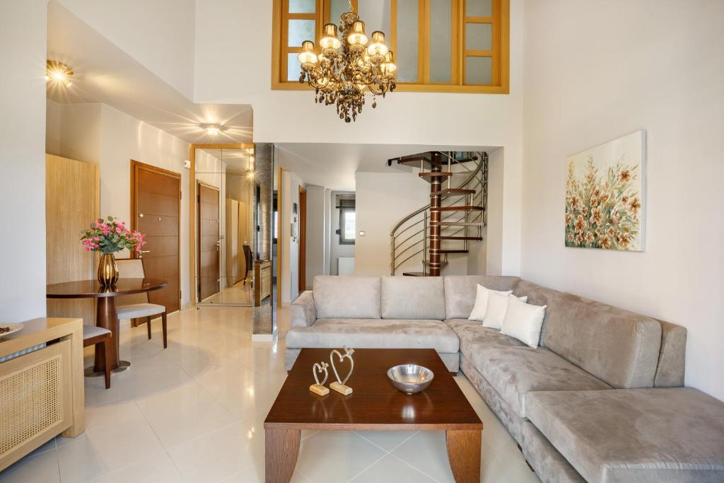 a living room with a couch and a table at Melon Suites in Thessaloniki