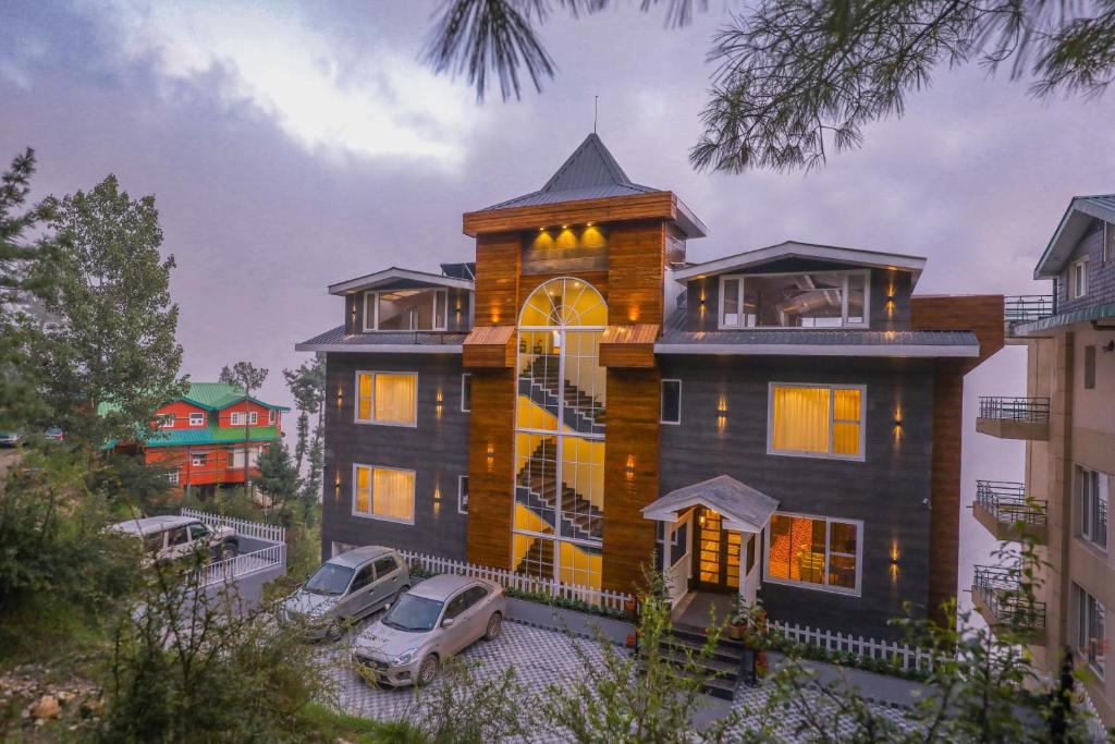 a large house with cars parked in front of it at The Retreat Mashobra, Shimla in Shimla