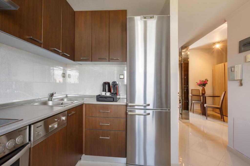 a kitchen with a stainless steel refrigerator at Melon Suites in Thessaloniki