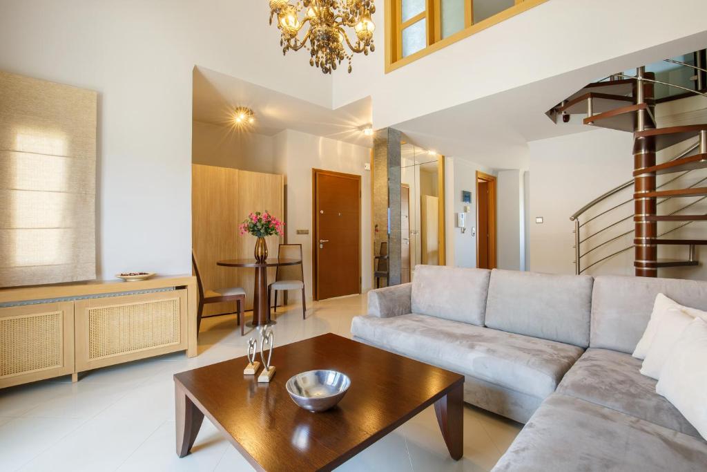 a living room with a couch and a table at Melon Suites in Thessaloniki