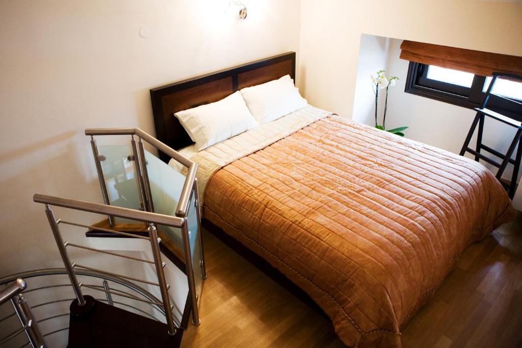 a bedroom with a bed and a glass table at Melon Suites in Thessaloniki