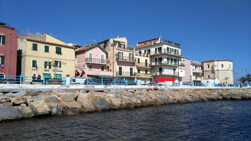a group of buildings next to a body of water at Casa Cantina ad un passo dal mare in Santo Stefano al Mare