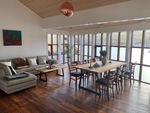 a living room with a table and chairs and a couch at Thor´s Guest house in Ryggur