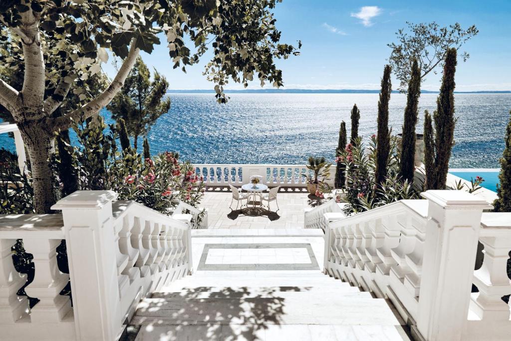 a white porch with a view of the water at Danai Beach Resort & Villas in Nikiti