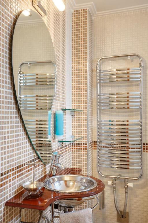 a bathroom with a sink and a mirror at Melon Suites in Thessaloniki