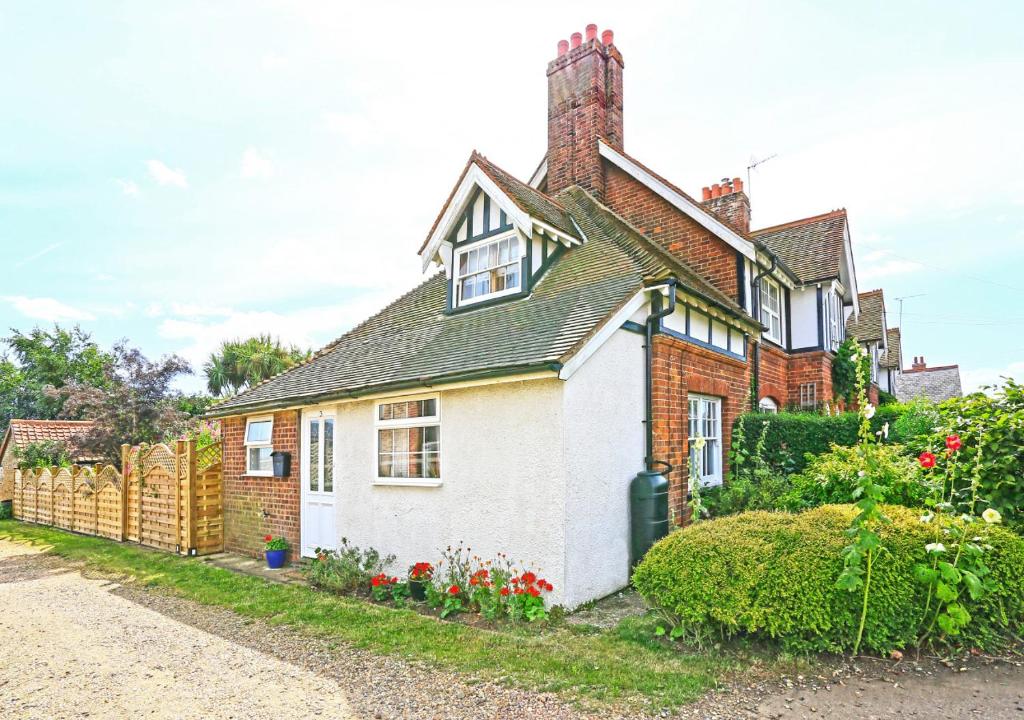 a small white house with a roof at Hollyhocks in Bawdsey