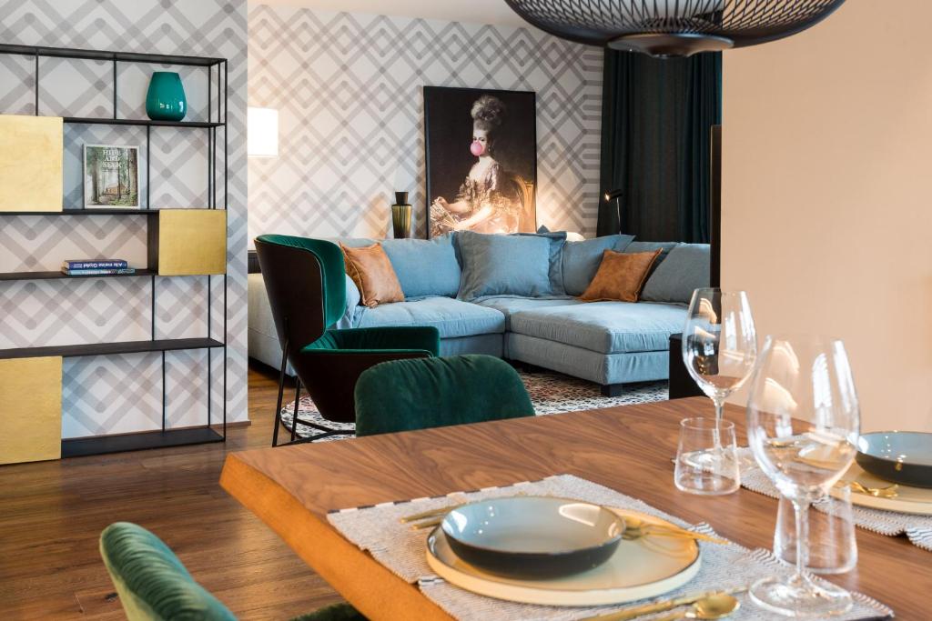 a living room with a blue couch and a table at ANTON Dolomites Hideaway in Brunico