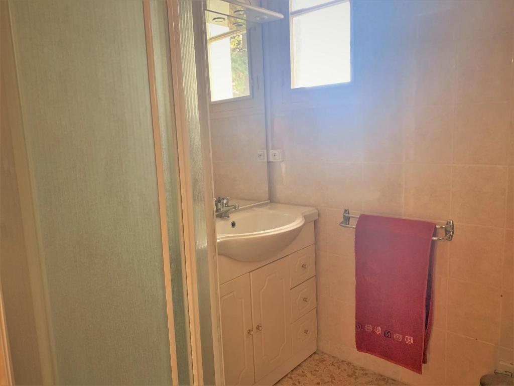 a bathroom with a sink and a mirror and a towel at LA PROVENÇALE in Orange