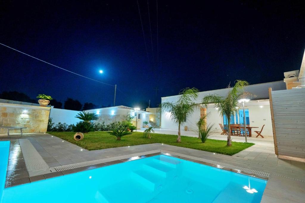 a villa with a swimming pool at night at Villa Gargasole con Piscina privata nel Salento in Alessano