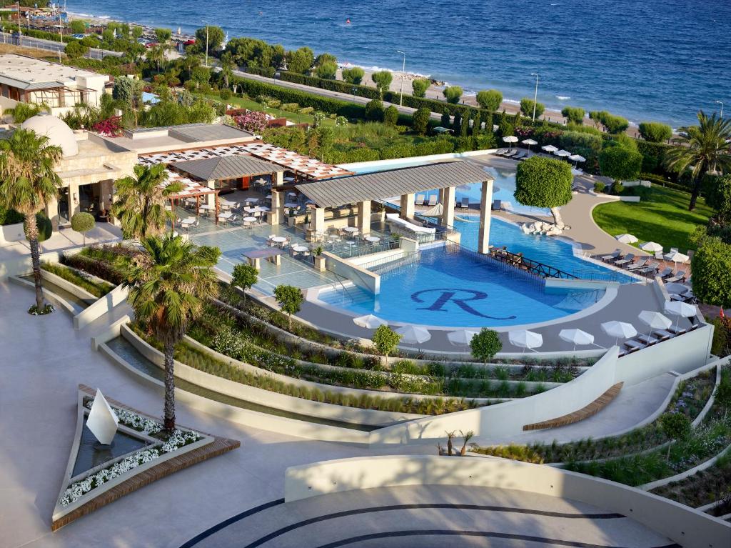 a beach with a pool and a large swimming pool at Rhodes Bay Hotel & Spa in Ixia