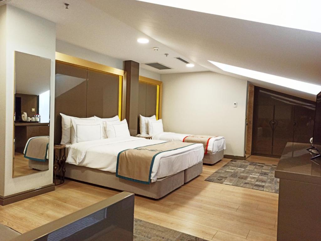 Postel nebo postele na pokoji v ubytování Peyk Hotel Oldcity