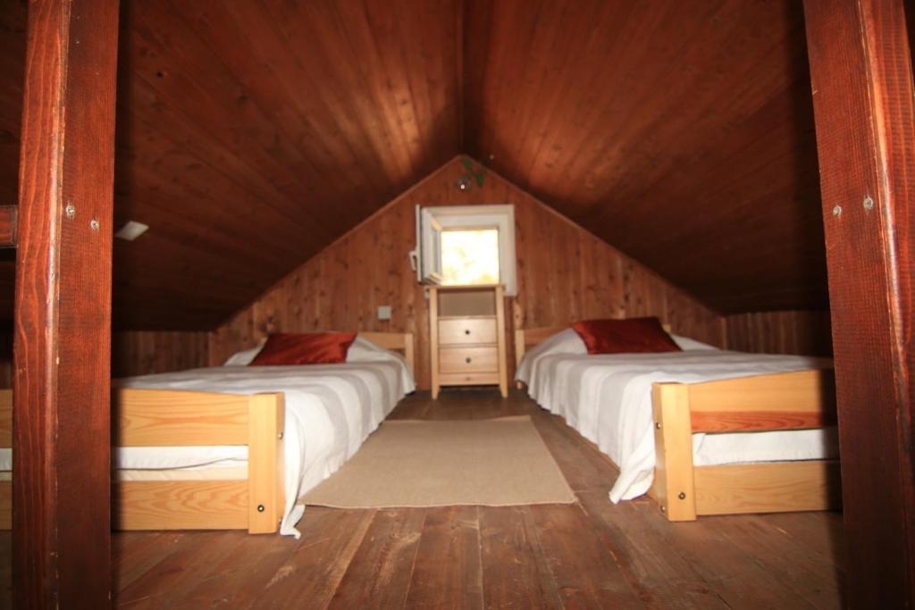a bedroom with two beds in a wooden house at Holiday home Ivan Bol in Bol