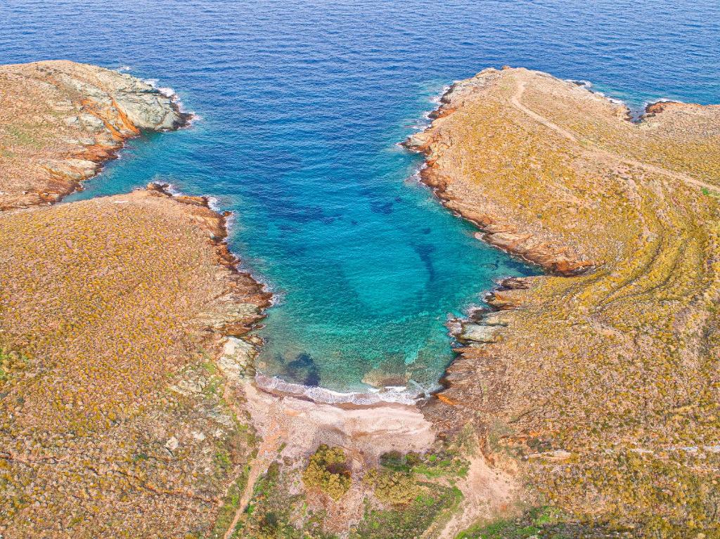 an aerial view of a pool of water on a cliff at Amelia Beachfront Villa in Korissia