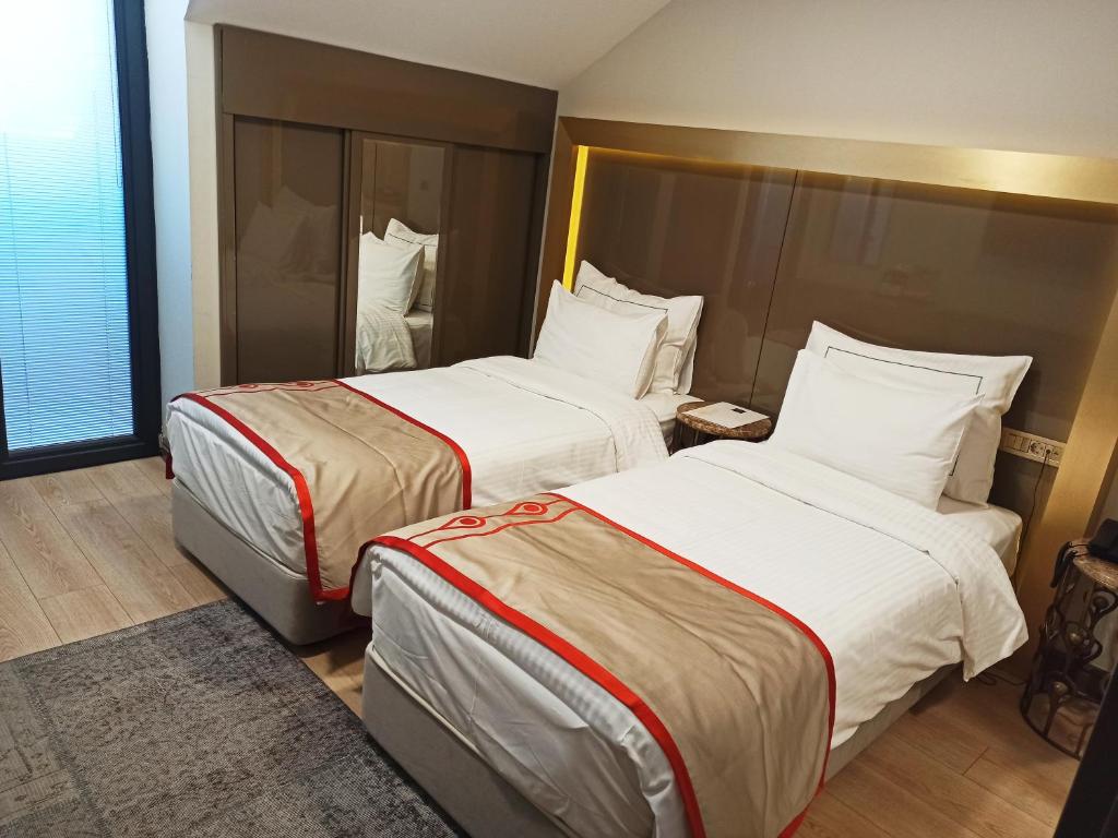 Postel nebo postele na pokoji v ubytování Peyk Hotel Oldcity
