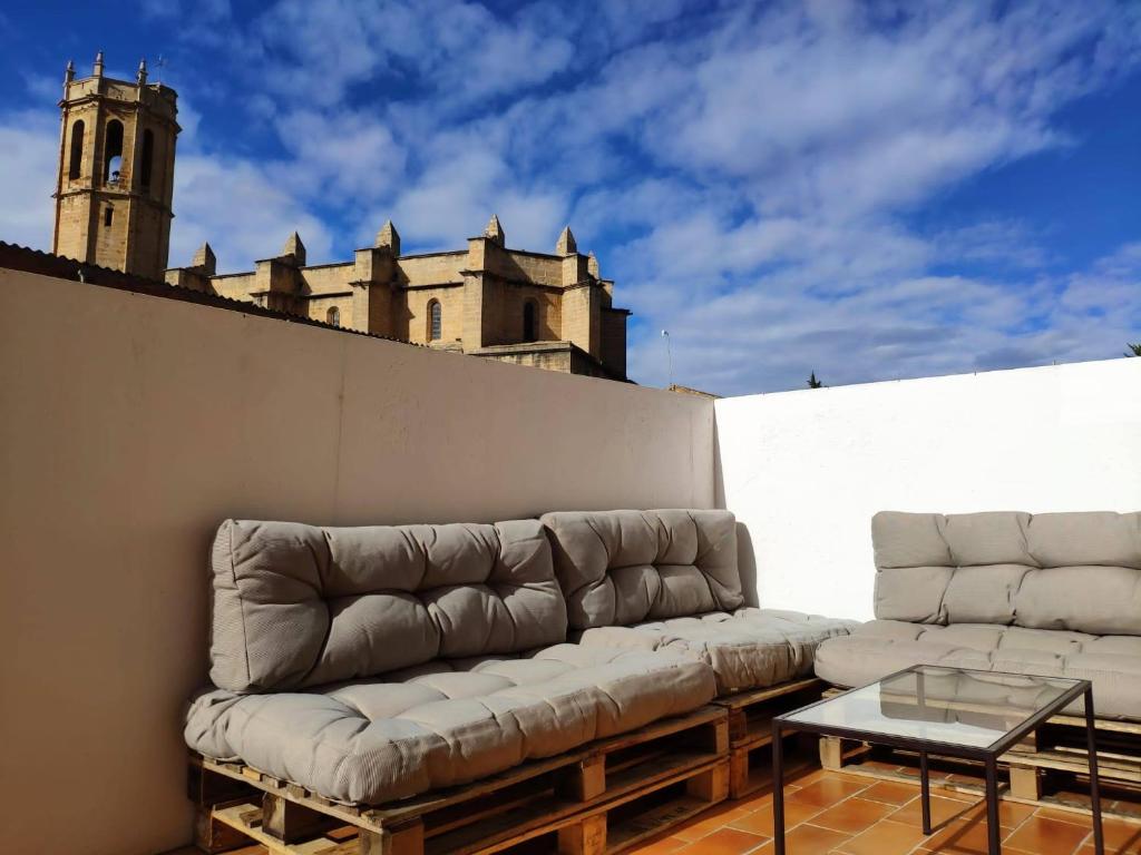 a couch sitting on top of a wall with a table at Casa Mineta in Cretas