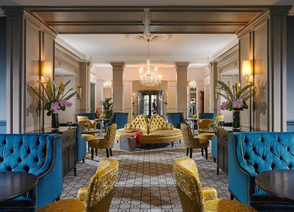 a lobby with blue chairs and a couch at The Hardiman (formerly Hotel Meyrick) in Galway