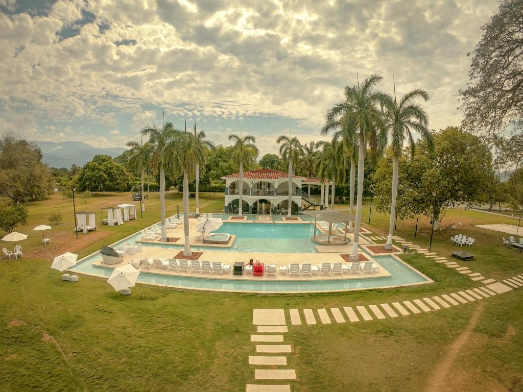 an aerial view of a swimming pool with a resort at Hotel Arena Santa Fe de Antioquia in Santa Fe de Antioquia