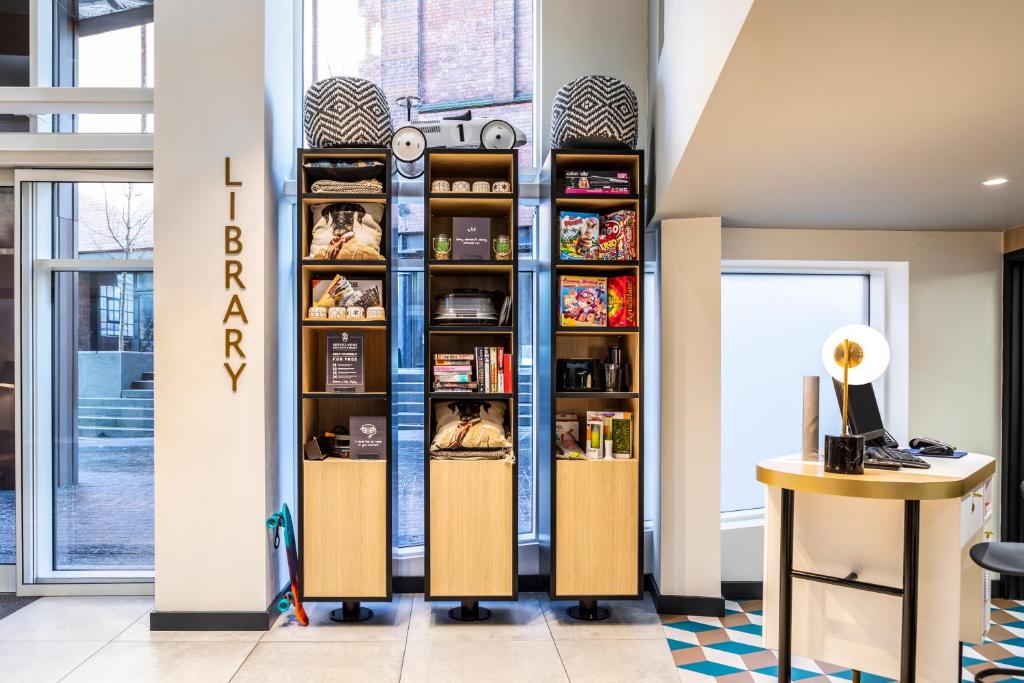 a room with a wall of shelves at Aparthotel Adagio Birmingham City Centre in Birmingham
