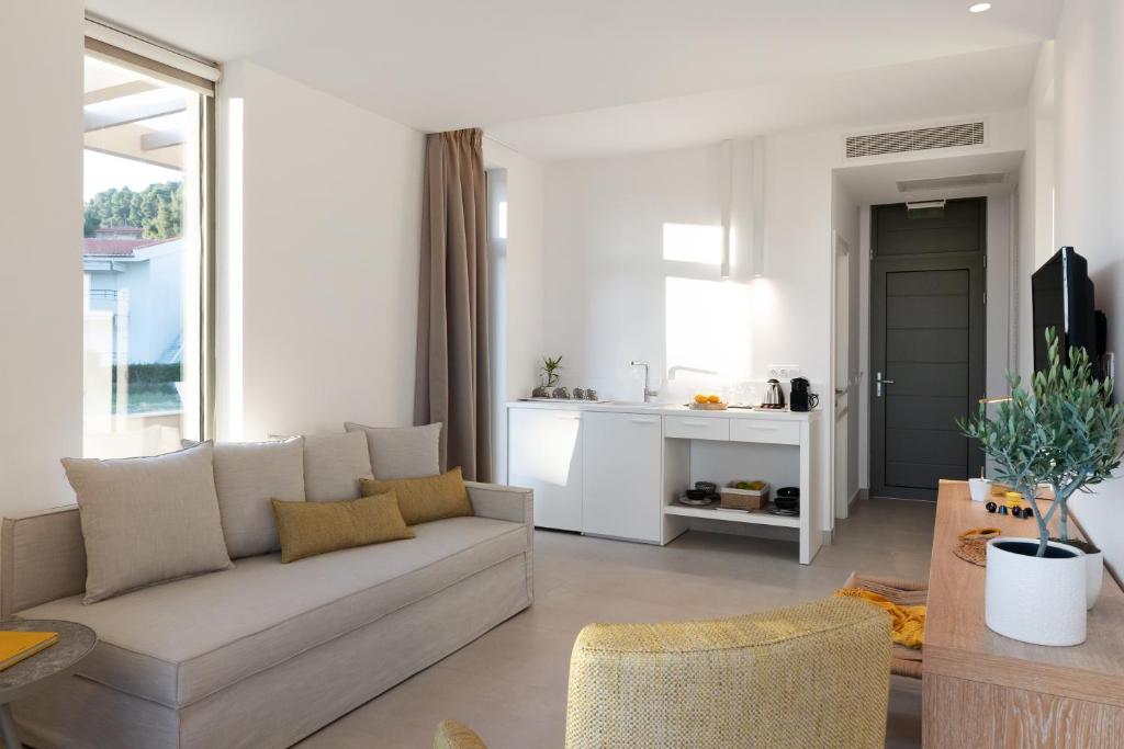 A television and/or entertainment centre at Cavo Delea Villas & Suites