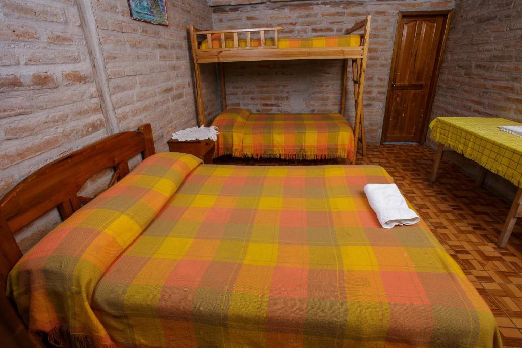 Postel nebo postele na pokoji v ubytování Estancia, CABAÑAS INTAG