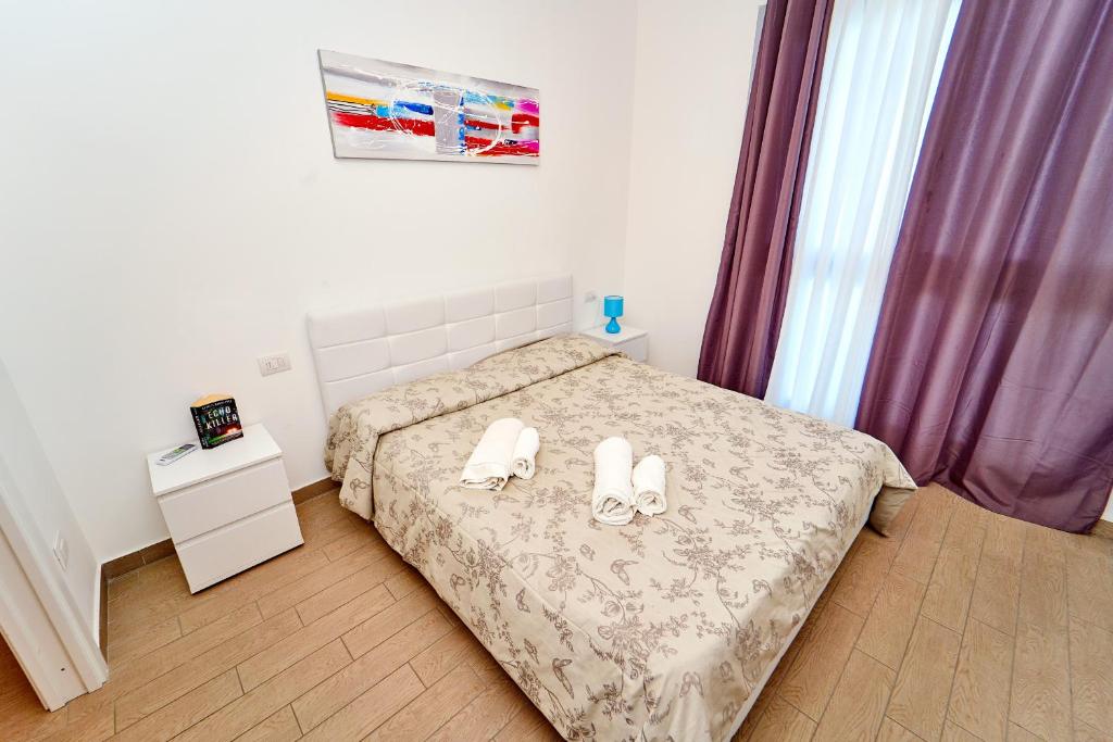 A bed or beds in a room at Affittimoderni Castelsardo Miramare