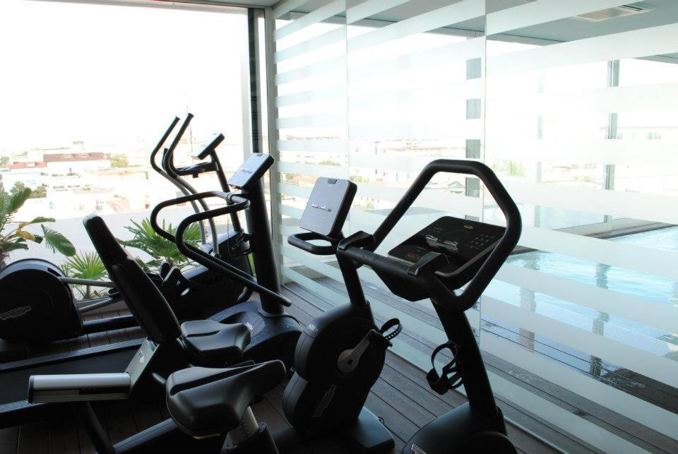 two exercise bikes in a gym next to a window at Il Teatro in Lido di Jesolo