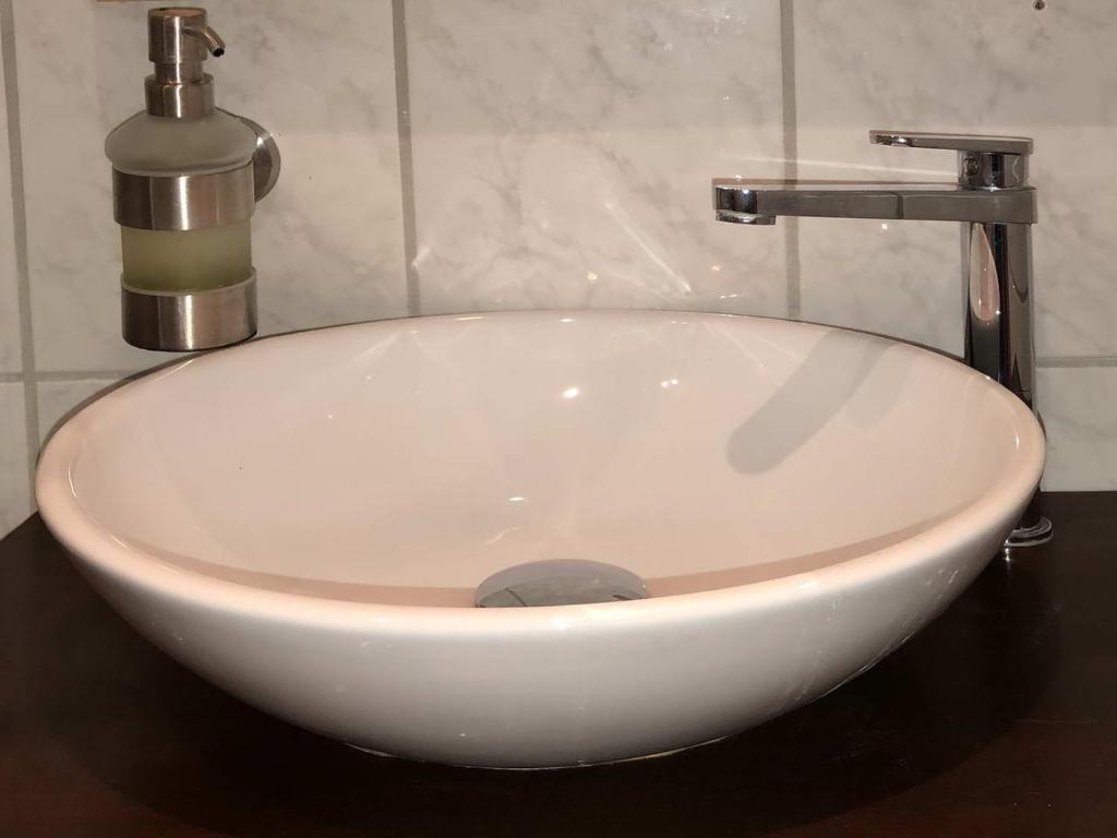 a white sink with a faucet in a bathroom at Landlust Hotel in Gransee